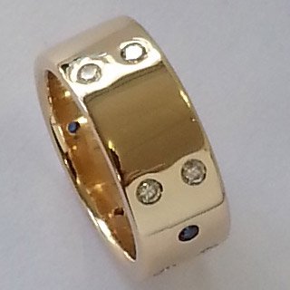 9kt yellow gold ring with flush set diamonds and sapphires