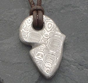 Pattern welded stainless steel pendant - africa